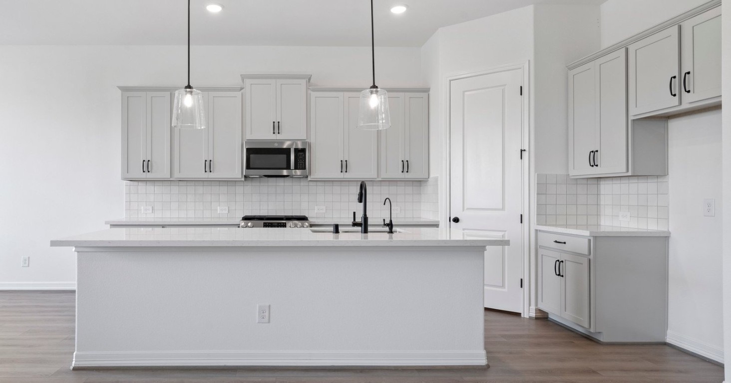 32107 Waterlily View Hockley, TX 77447 - Photo 3 of 21 a kitchen with stainless steel appliances granite countertop a sink a stove and a refrigerator