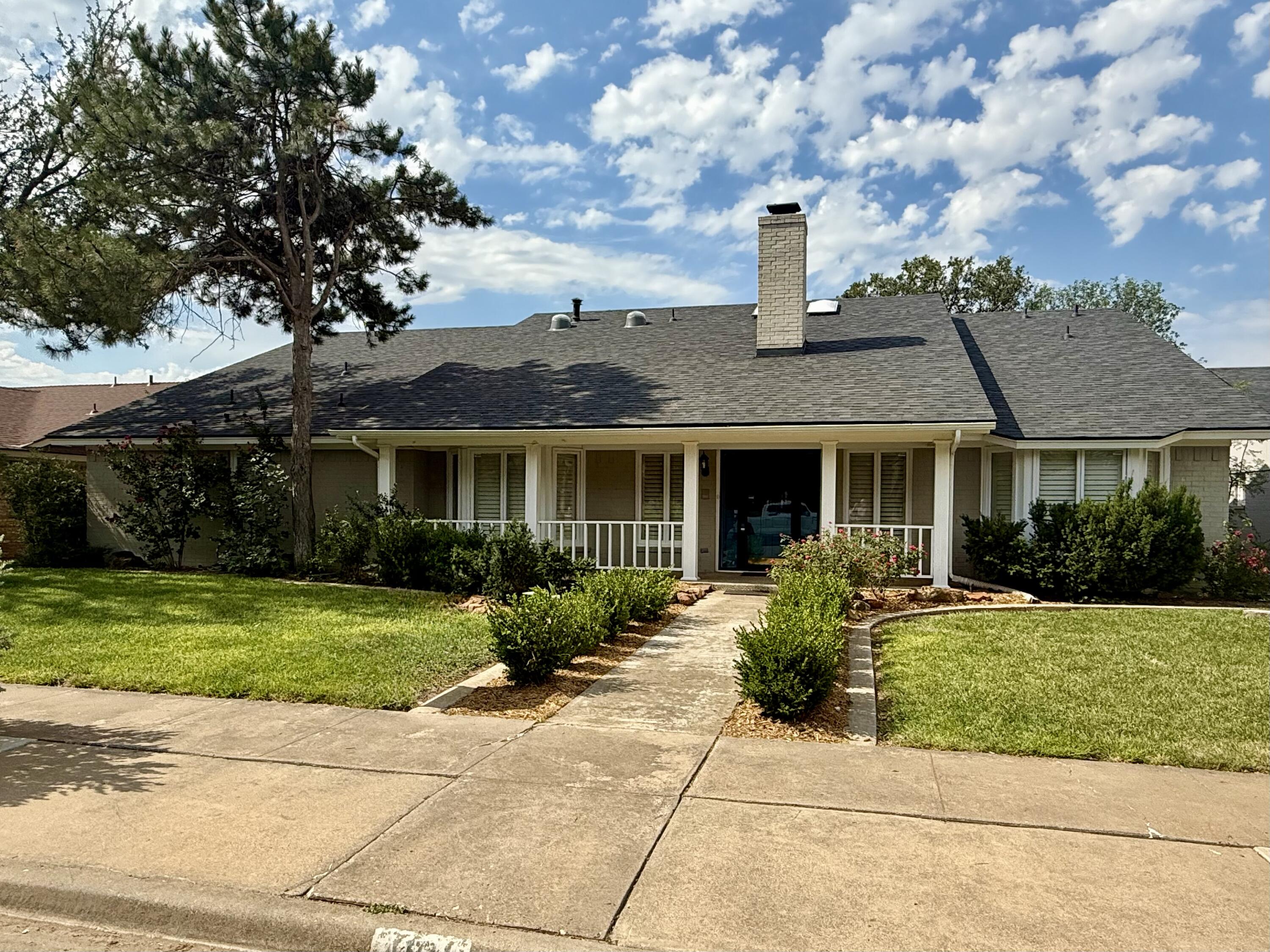 4911 92nd Street Lubbock, TX 79424 - Photo 1 of 77 a front view of a house with garden