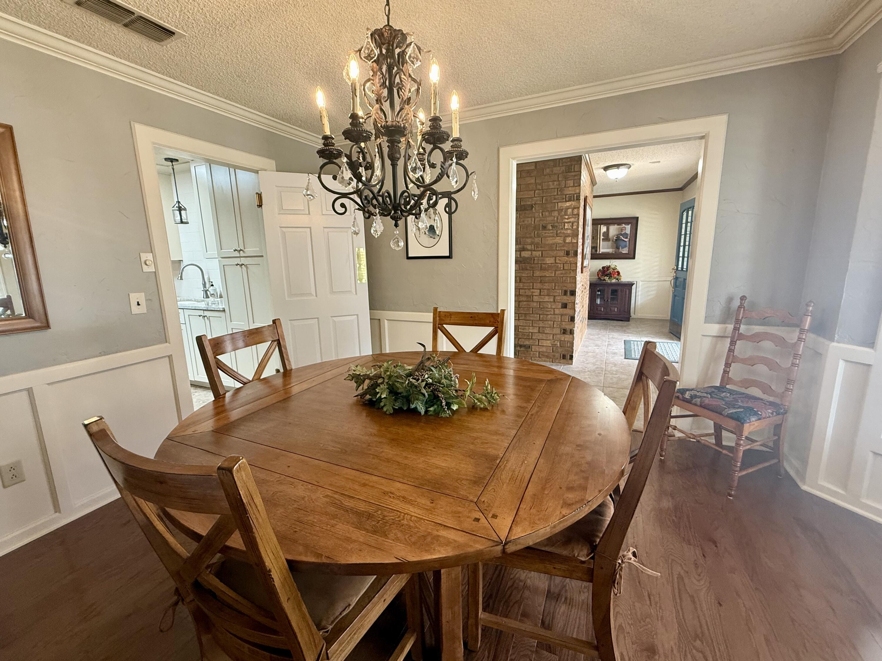 4911 92nd Street Lubbock, TX 79424 - Photo 15 of 77 a view of a dining room with furniture and wooden floor