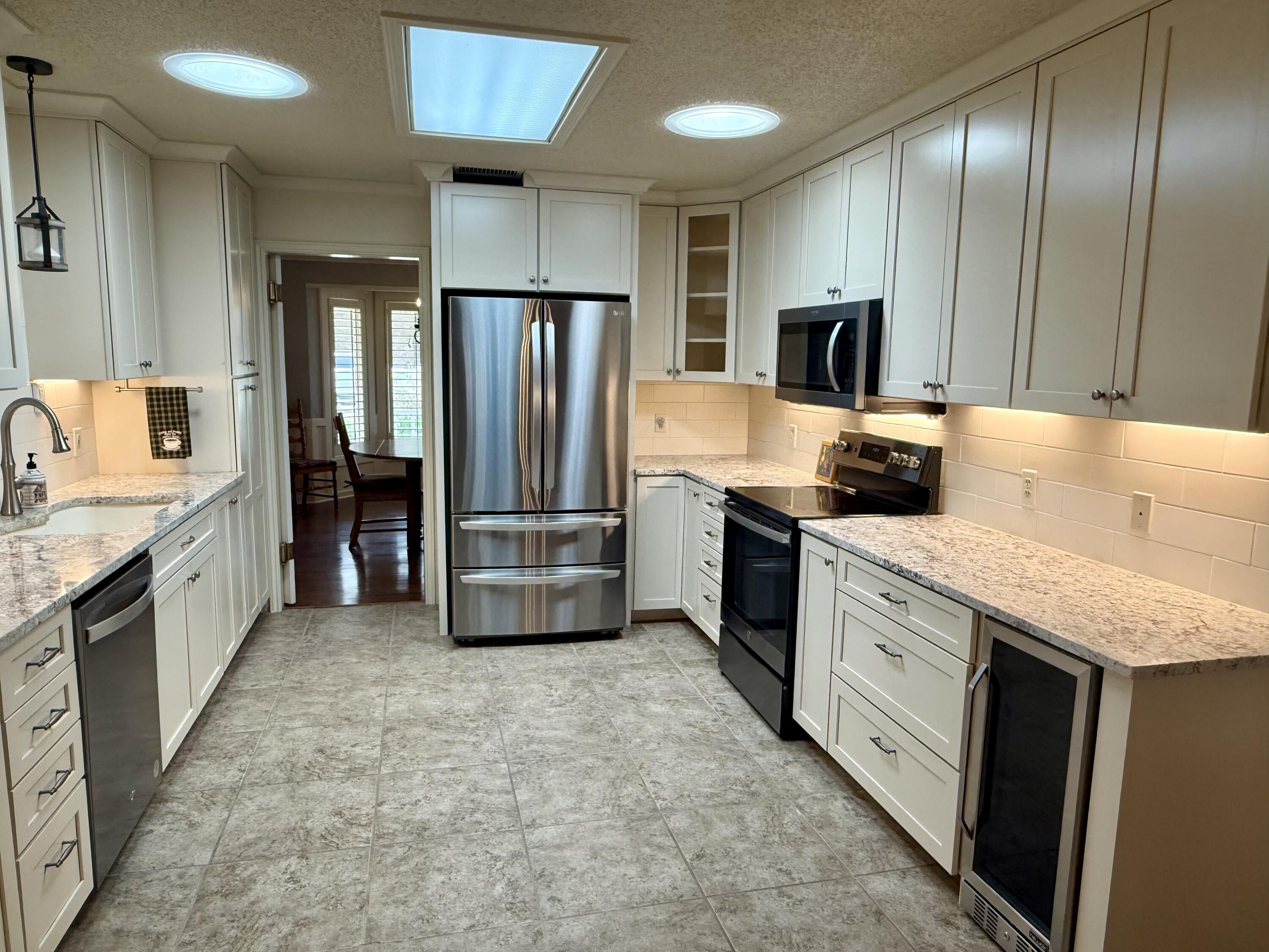 4911 92nd Street Lubbock, TX 79424 - Photo 17 of 77 a kitchen with stainless steel appliances granite countertop a refrigerator and a stove