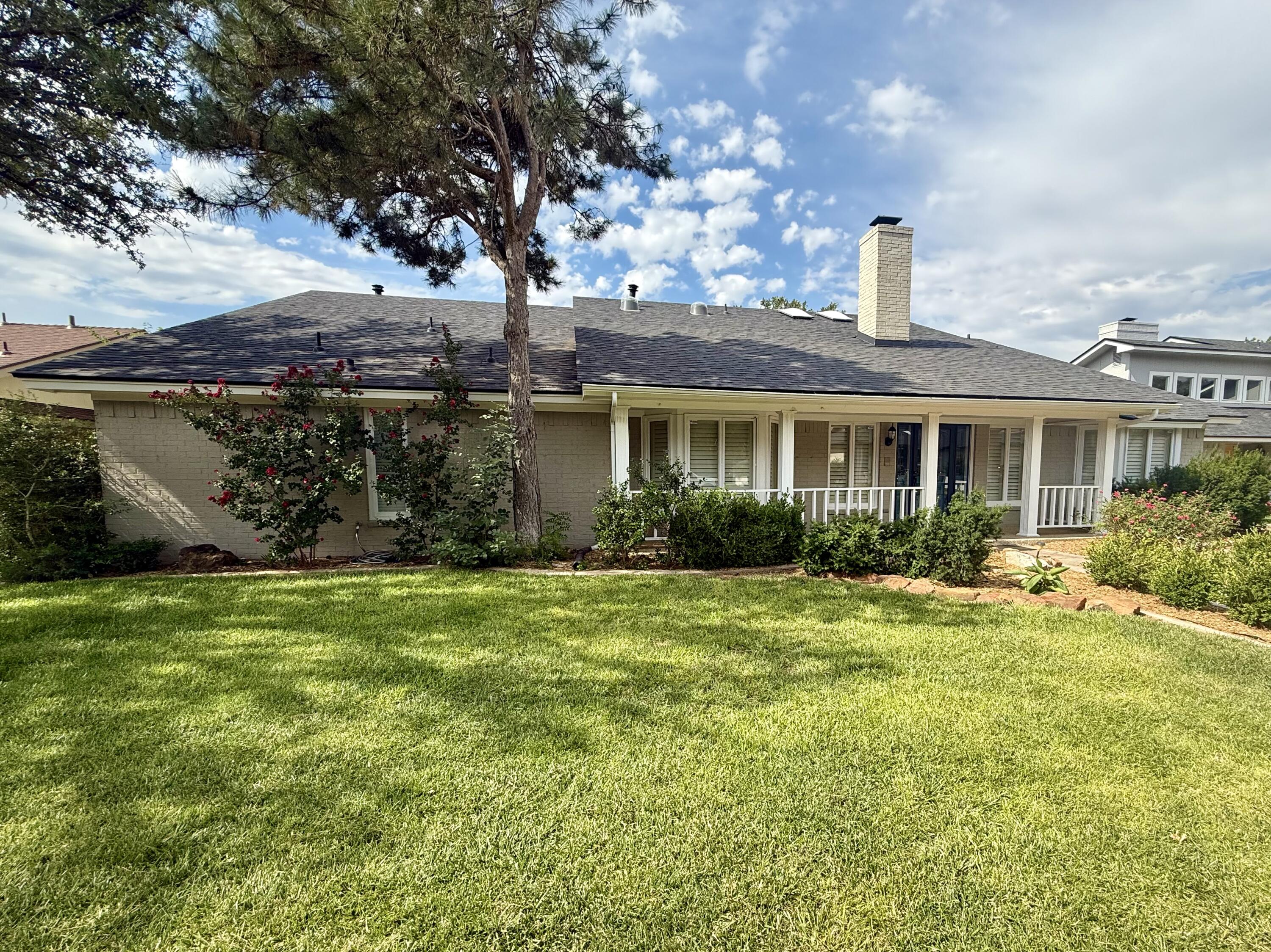4911 92nd Street Lubbock, TX 79424 - Photo 2 of 77 a front view of a house with a garden