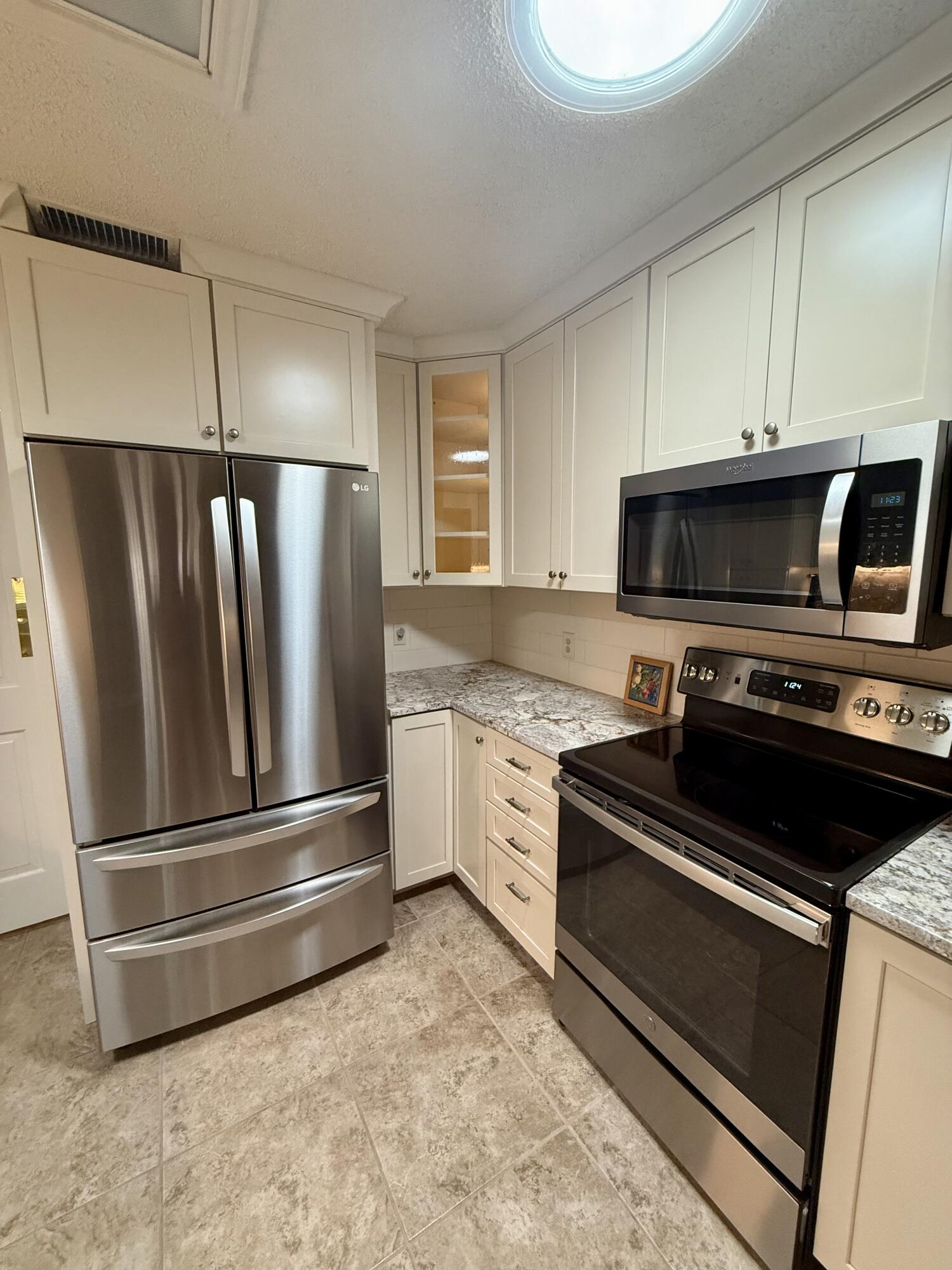 4911 92nd Street Lubbock, TX 79424 - Photo 26 of 77 a kitchen with a refrigerator stove and microwave