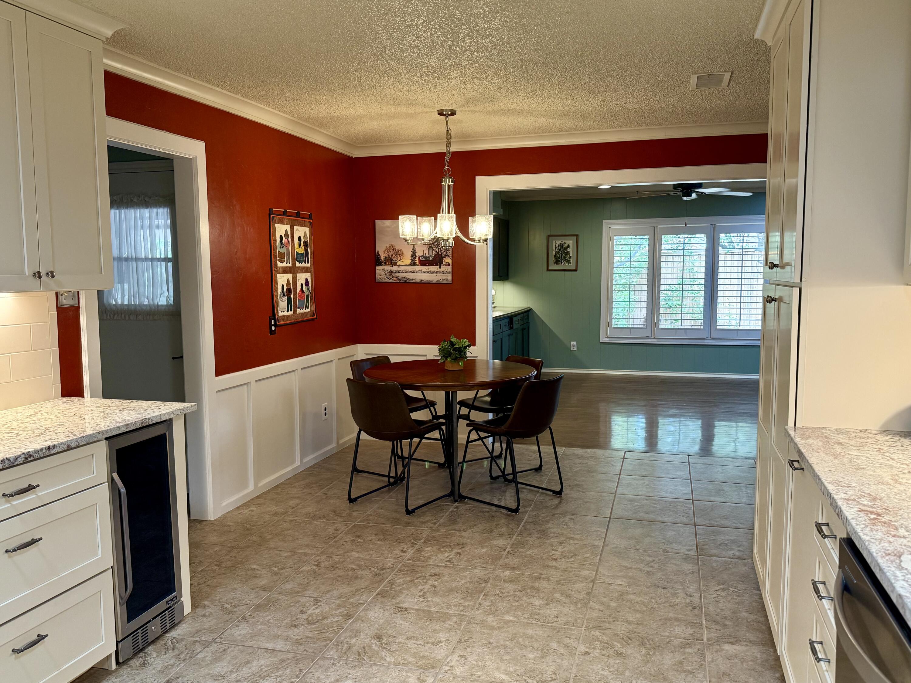 4911 92nd Street Lubbock, TX 79424 - Photo 28 of 77 a view of a dining room with furniture and chandelier