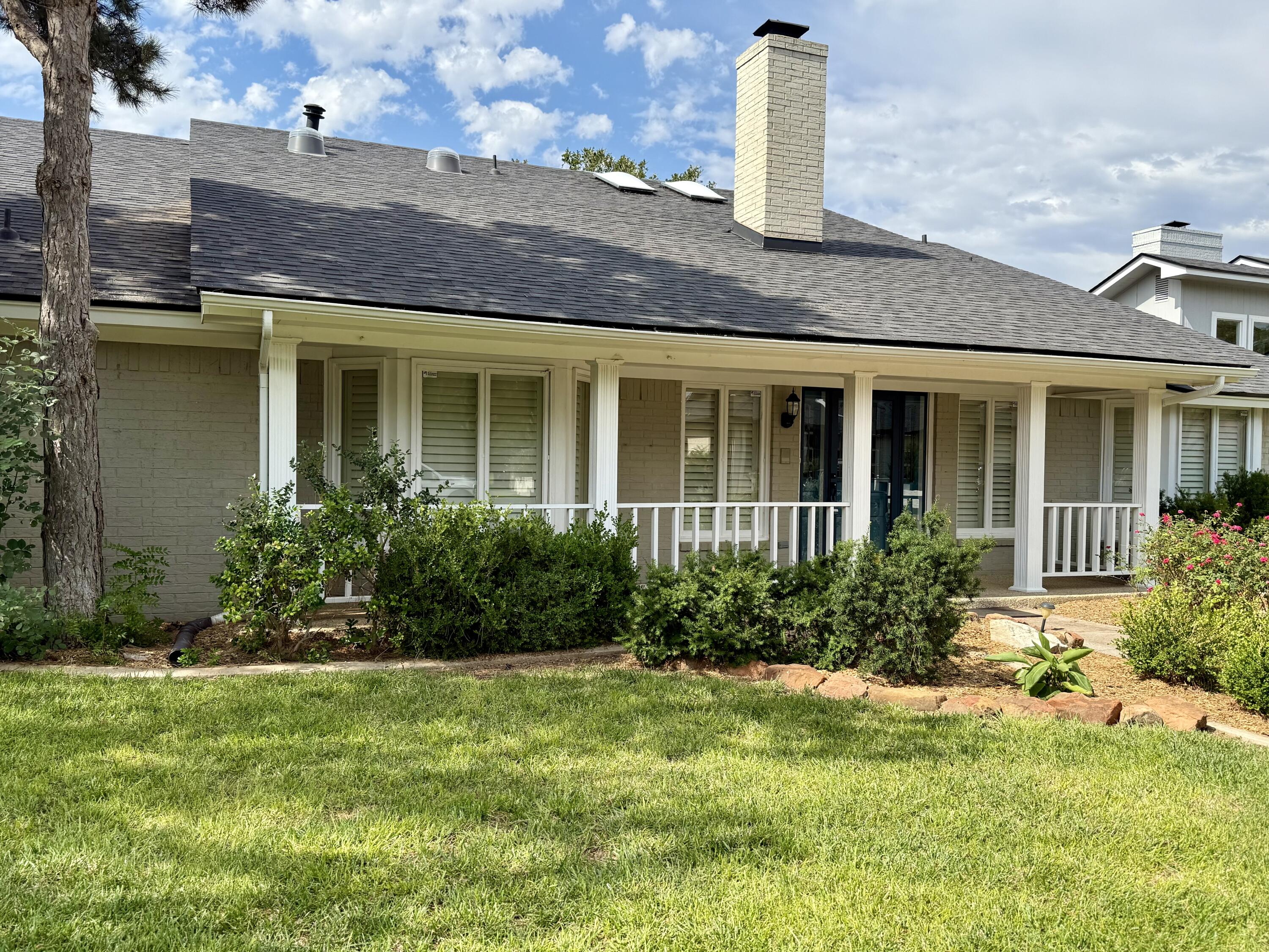 4911 92nd Street Lubbock, TX 79424 - Photo 3 of 77 a front view of a house with garden