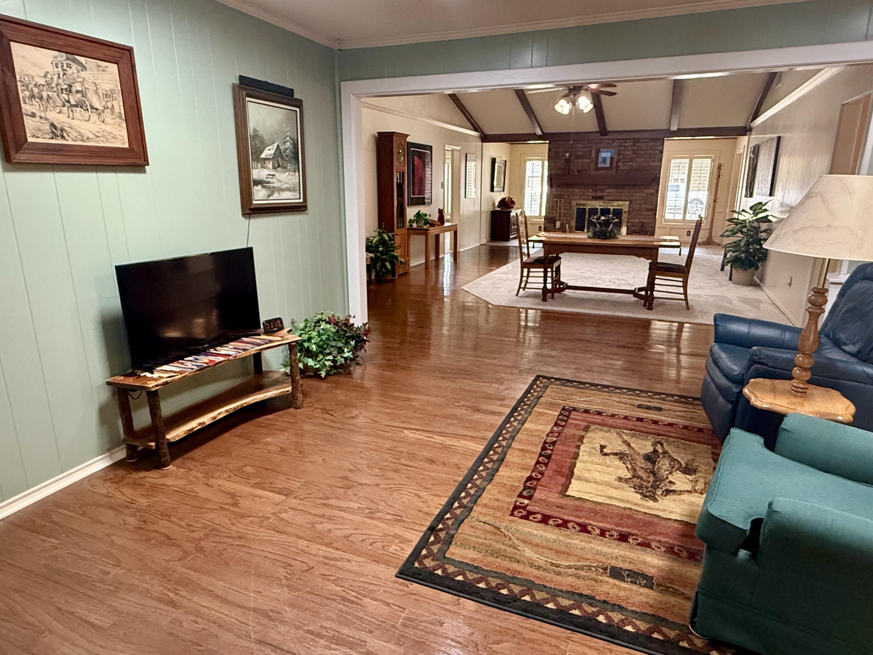 4911 92nd Street Lubbock, TX 79424 - Photo 38 of 77 a living room with furniture and a flat screen tv