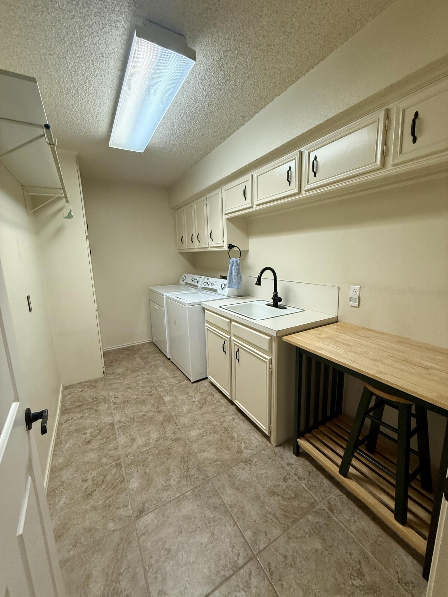 4911 92nd Street Lubbock, TX 79424 - Photo 53 of 77 a utility room with cabinets