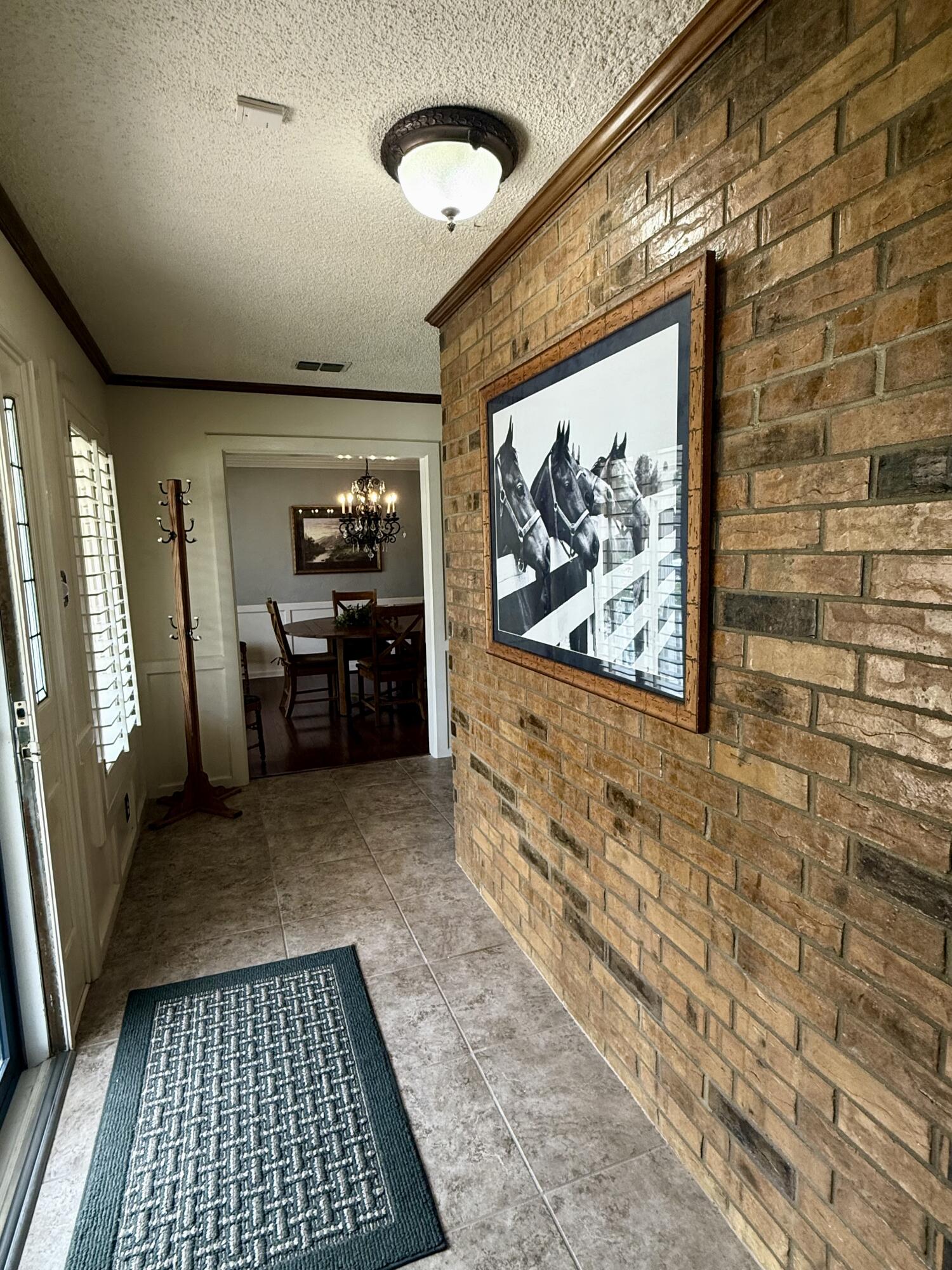 4911 92nd Street Lubbock, TX 79424 - Photo 6 of 77 a view of a hallway with wooden floor and furniture