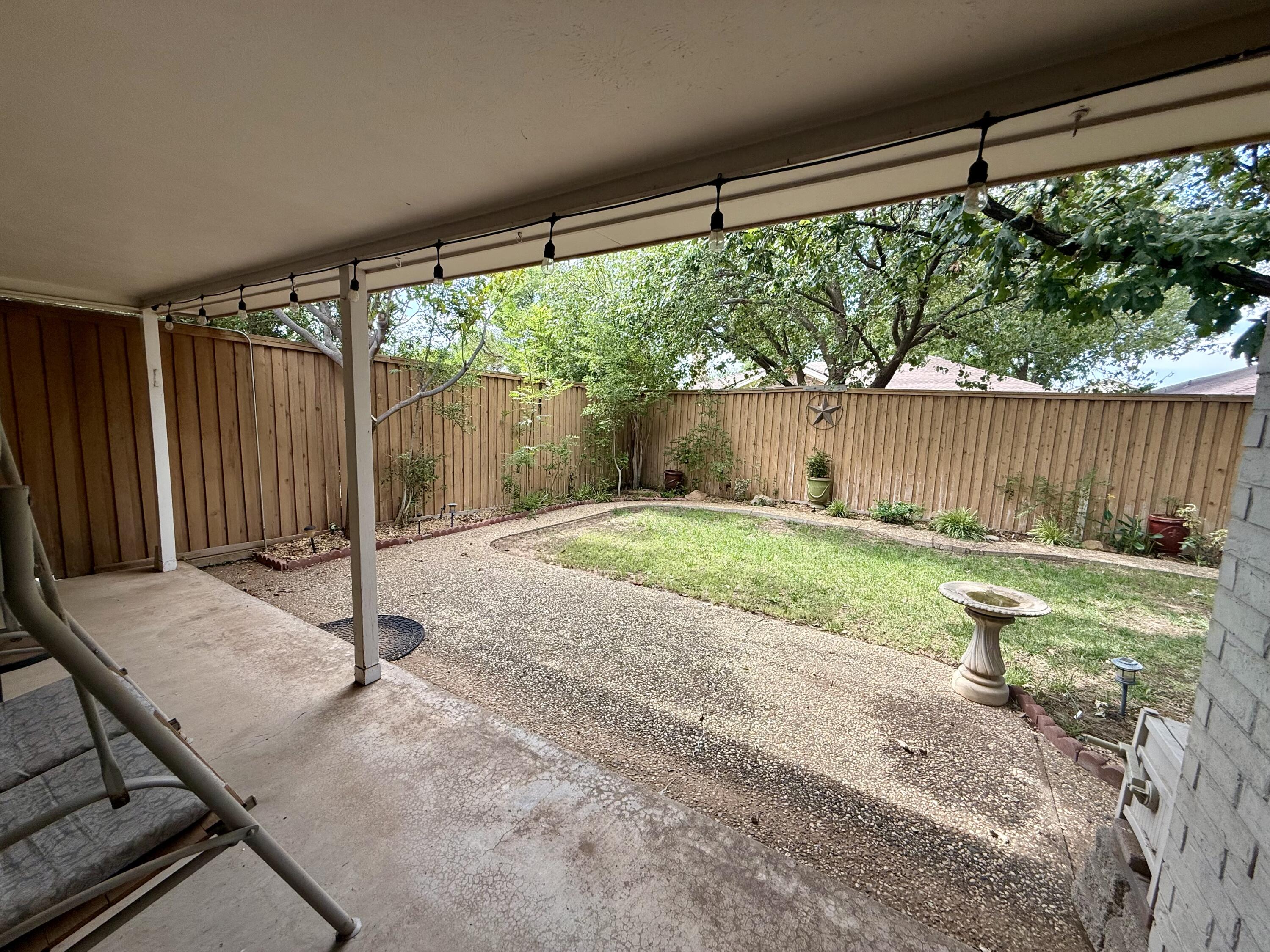 4911 92nd Street Lubbock, TX 79424 - Photo 69 of 77 a view of a backyard with a small cabin