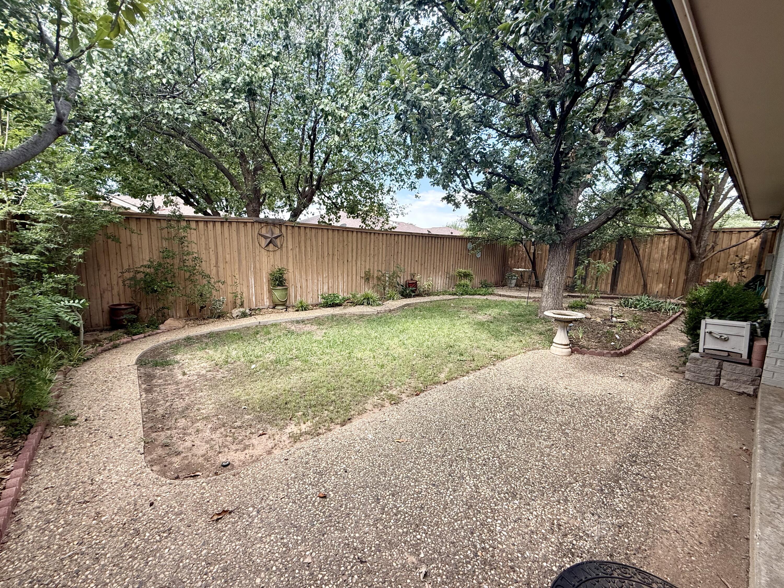 4911 92nd Street Lubbock, TX 79424 - Photo 71 of 77 a backyard of a house with lots of green space