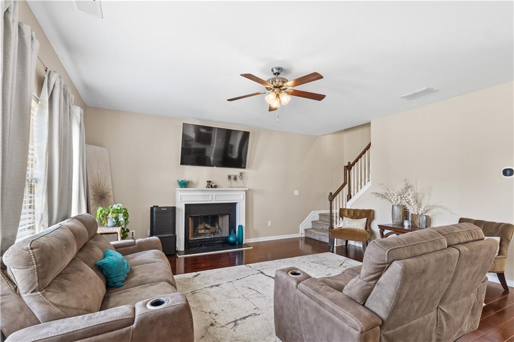 9116 Alden Drive Locust Grove, GA 30248 - Photo 14 of 27 a living room with furniture a fireplace and a flat screen tv