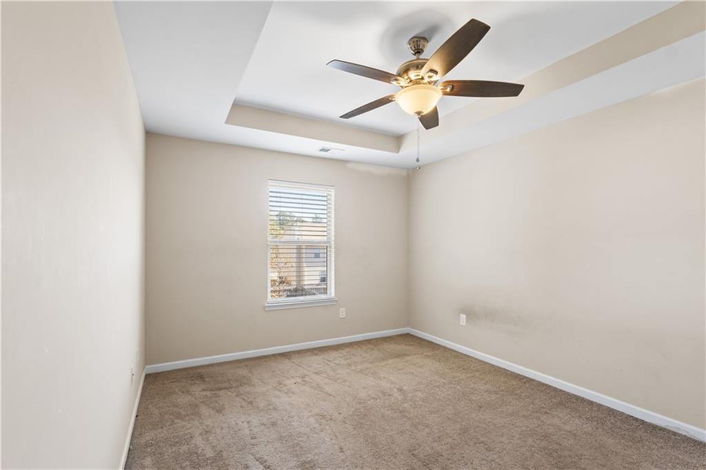 9116 Alden Drive Locust Grove, GA 30248 - Photo 19 of 27 an empty room with window and ceiling fan