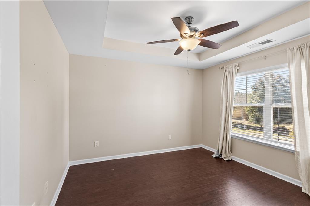 9116 Alden Drive Locust Grove, GA 30248 - Photo 23 of 27 an empty room with ceiling fan and window