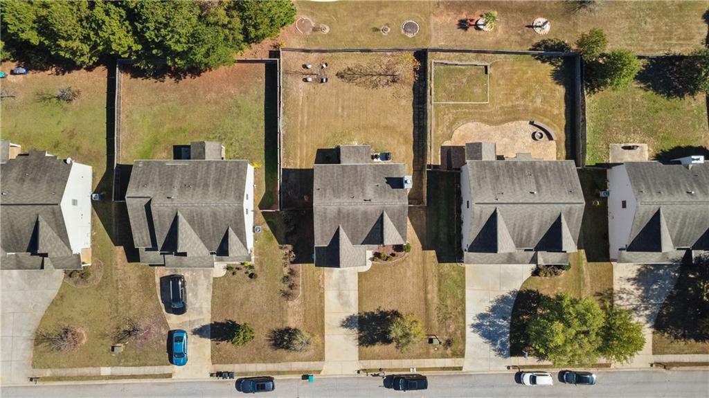 9116 Alden Drive Locust Grove, GA 30248 - Photo 25 of 27 an aerial view of residential houses with outdoor space and parking