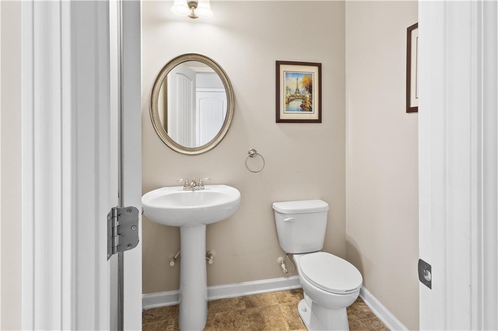 9116 Alden Drive Locust Grove, GA 30248 - Photo 9 of 27 a bathroom with a toilet a sink and a mirror