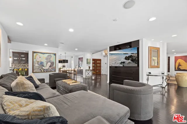 a kitchen with stainless steel appliances granite countertop a table chairs stove and sink