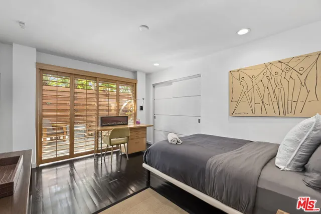 a front view of a house with swimming pool having outdoor seating