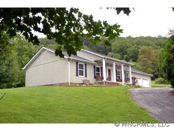 171 Vision Road Canton, NC 28716 - Photo 1 of 17 a big white house with a big yard and large trees