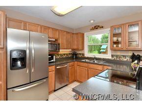 171 Vision Road Canton, NC 28716 - Photo 5 of 17 a kitchen with stainless steel appliances granite countertop a refrigerator a sink a stove and island