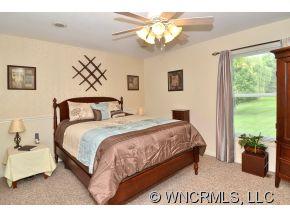 171 Vision Road Canton, NC 28716 - Photo 8 of 17 a bedroom with a large bed and a window