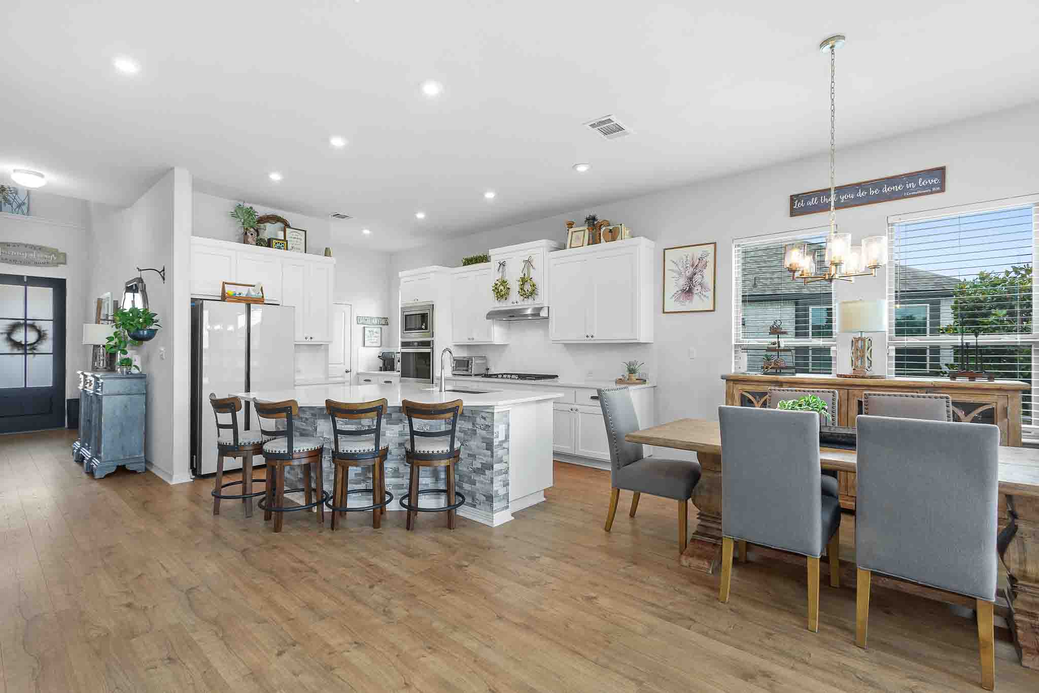 166 West Branch Road Kyle, TX 78640 - Photo 11 of 39 An open concept design seamlessly connects the kitchen and dining areas, fostering a welcoming atmosphere.