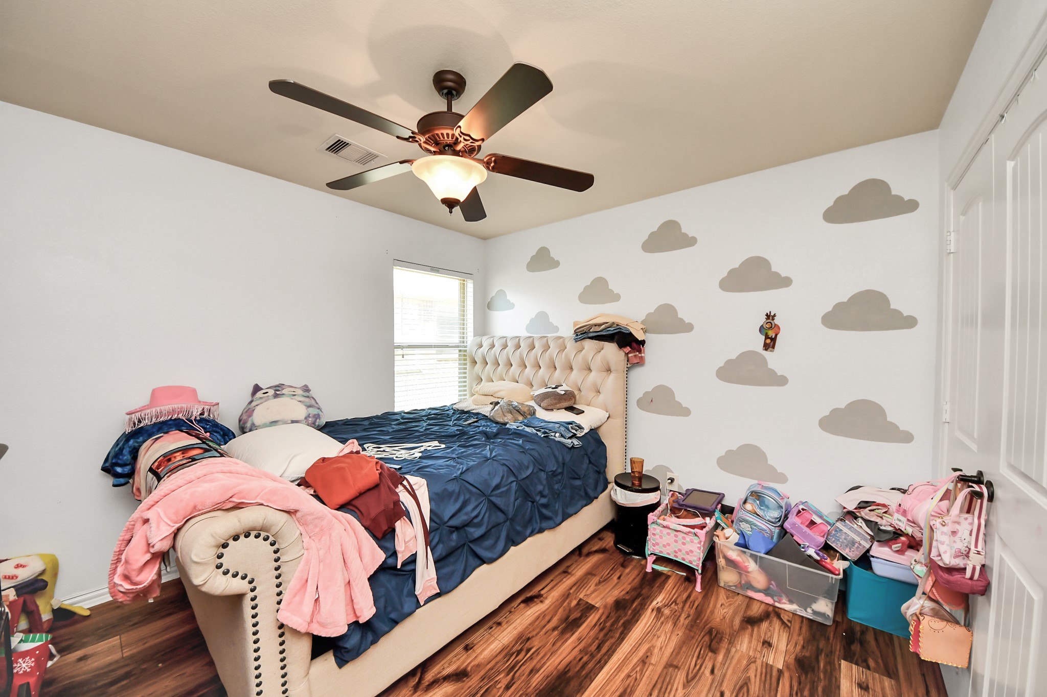 7502 Simpson Springs Lane Spring, TX 77389 - Photo 12 of 38 a bedroom with a bed and a chandelier
