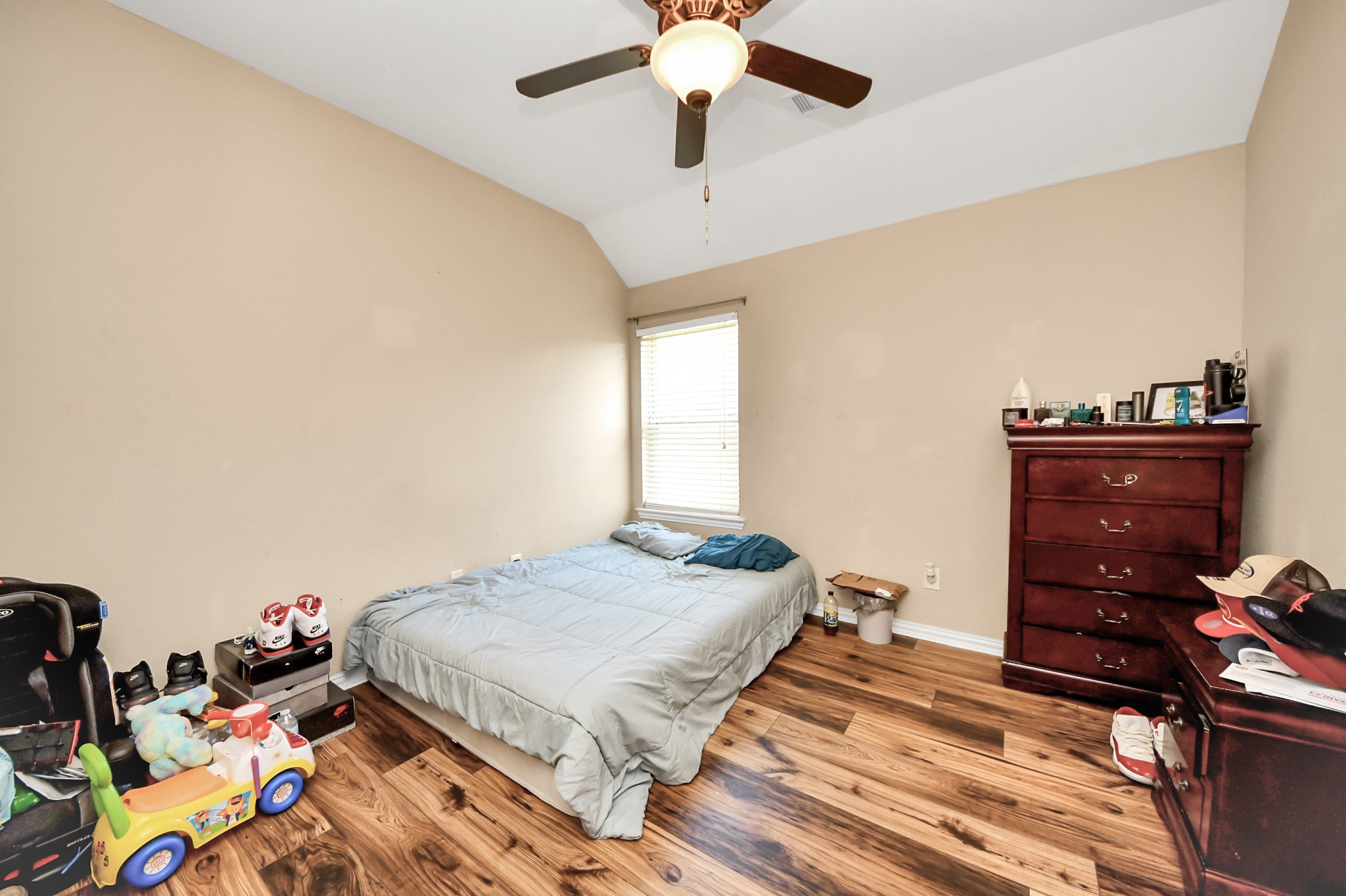 7502 Simpson Springs Lane Spring, TX 77389 - Photo 14 of 38 a bedroom with a bed and a chandelier