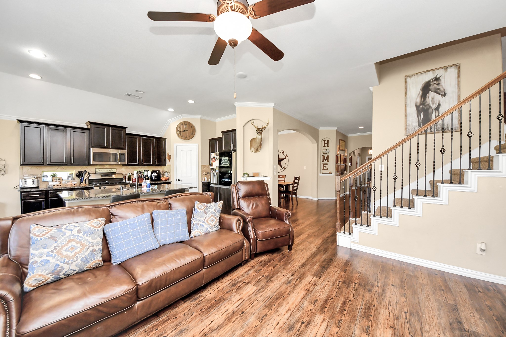 7502 Simpson Springs Lane Spring, TX 77389 - Photo 21 of 38 a living room with furniture kitchen view and a wooden floor