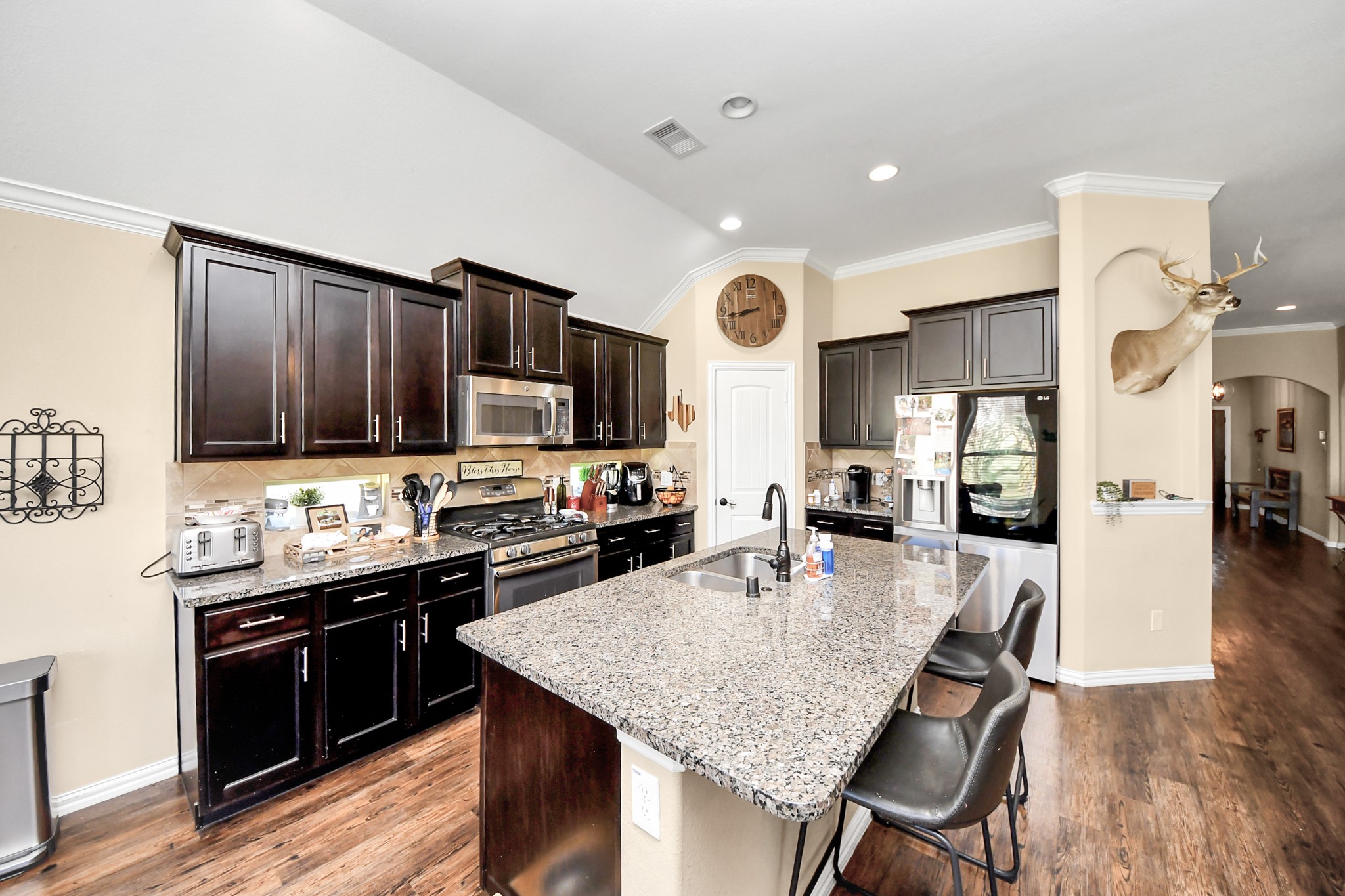 7502 Simpson Springs Lane Spring, TX 77389 - Photo 22 of 38 a kitchen with stainless steel appliances granite countertop a stove refrigerator sink and cabinets