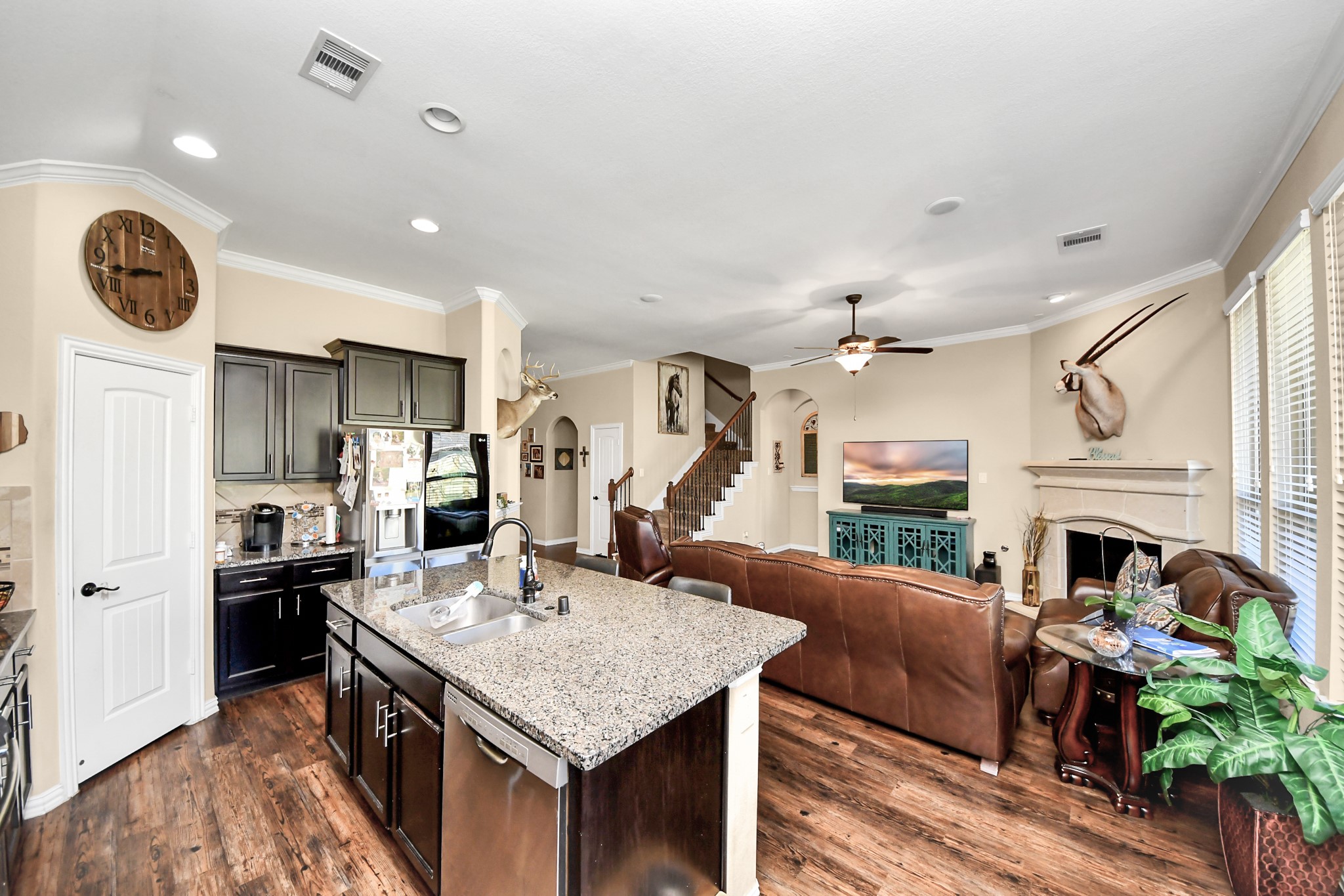 7502 Simpson Springs Lane Spring, TX 77389 - Photo 23 of 38 a open kitchen with stainless steel appliances granite countertop a stove and a fireplace