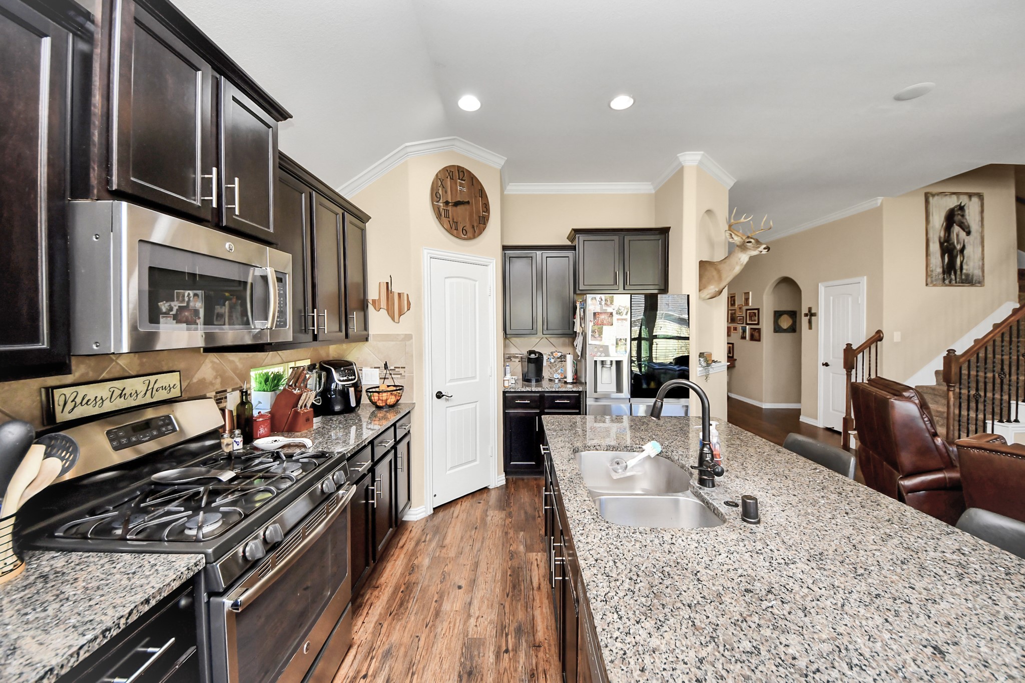 7502 Simpson Springs Lane Spring, TX 77389 - Photo 24 of 38 a kitchen with stainless steel appliances granite countertop a stove oven and a refrigerator