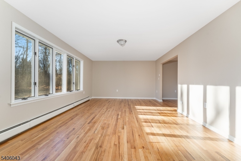 333 Mt Bethel Road Port Murray, NJ 07865 - Photo 12 of 47 a view of an empty room with wooden floor and a window