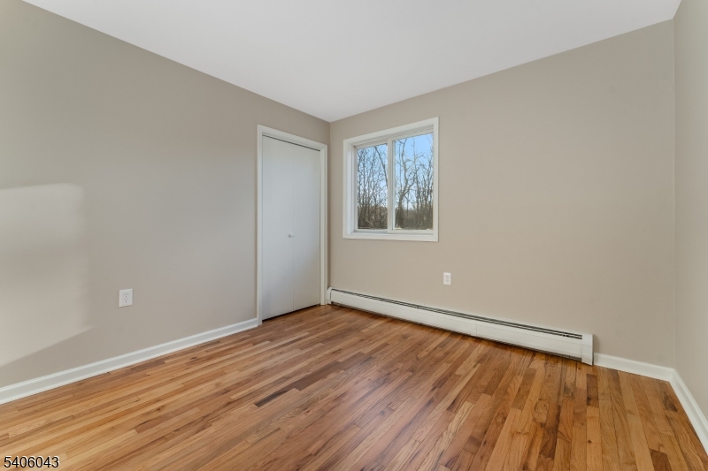 333 Mt Bethel Road Port Murray, NJ 07865 - Photo 23 of 47 a view of an empty room with wooden floor and a window