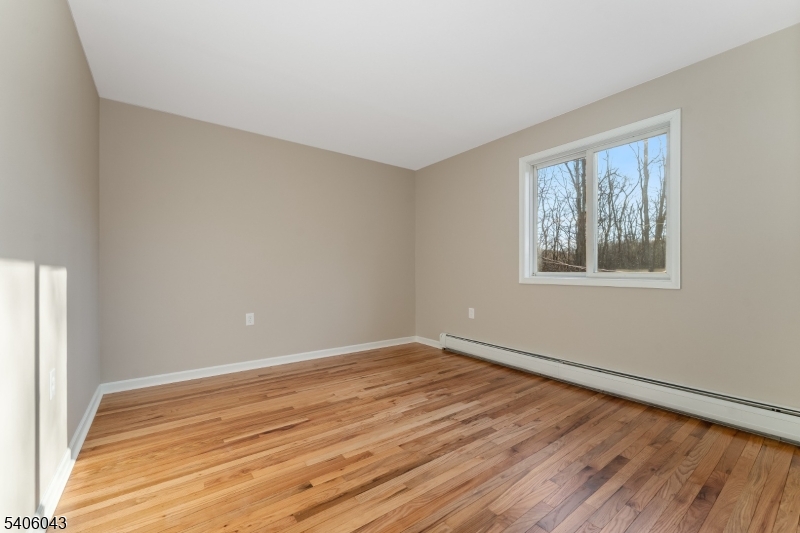 333 Mt Bethel Road Port Murray, NJ 07865 - Photo 24 of 47 a view of an empty room with wooden floor and a window