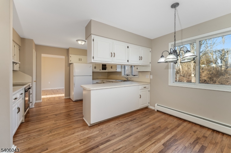 333 Mt Bethel Road Port Murray, NJ 07865 - Photo 7 of 47 a kitchen with cabinets wooden floor and a fireplace