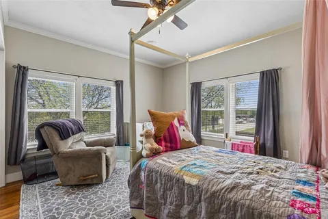 a bedroom with a large bed and a large window