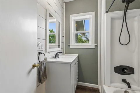 a bathroom with a sink a toilet and a window
