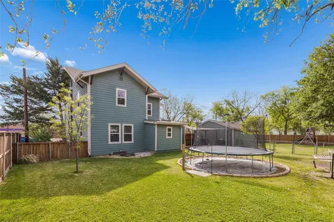 a backyard of a house with table and chairs