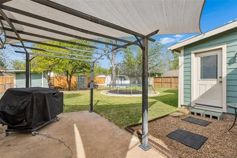 a view of a porch with furniture and a backyard