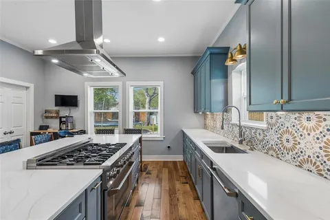 a kitchen with a sink stove and cabinets