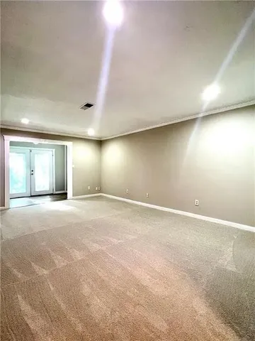 an empty room with window and pillar in it