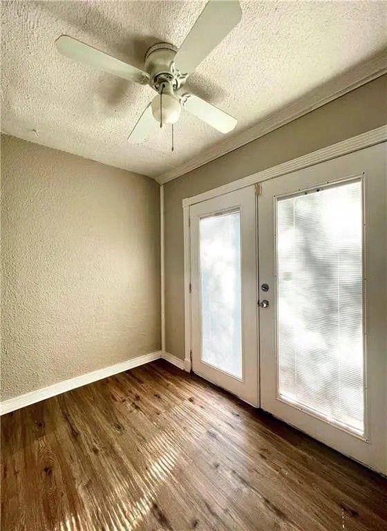 2390 Lawrenceville Highway, Unit A Decatur, GA 30033 - Photo 5 of 12 an empty room with wooden floor fan and windows