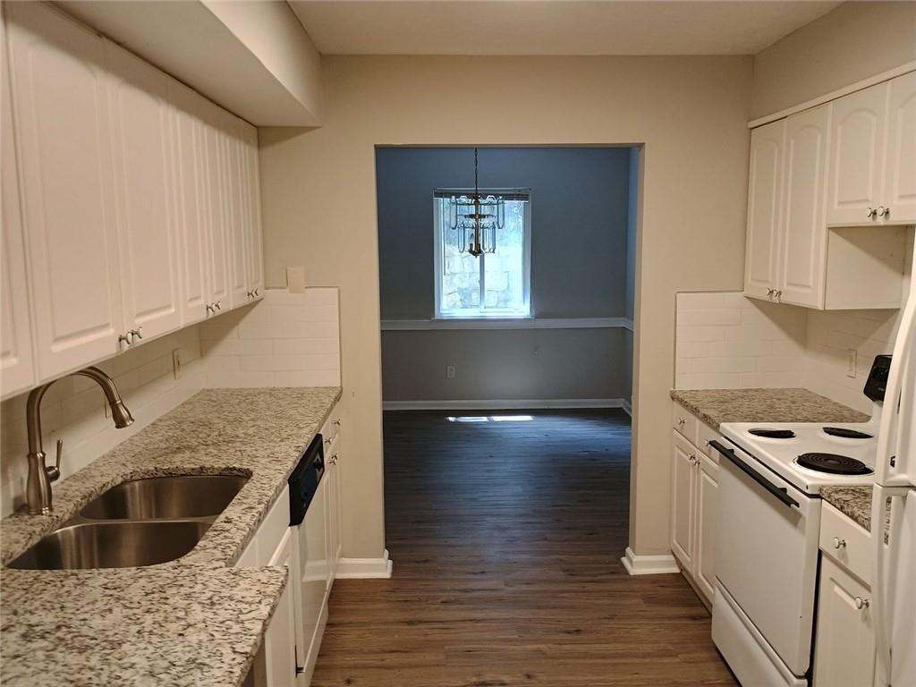 2390 Lawrenceville Highway, Unit A Decatur, GA 30033 - Photo 8 of 12 a kitchen with granite countertop a sink a stove and cabinets