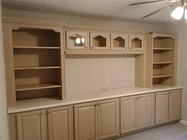 a view of a kitchen with white cabinets