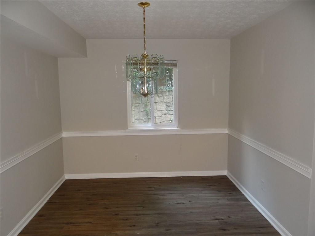 2390 Lawrenceville Highway, Unit A Decatur, GA 30033 - Photo 10 of 12 a view of an empty room with wooden floor and a window