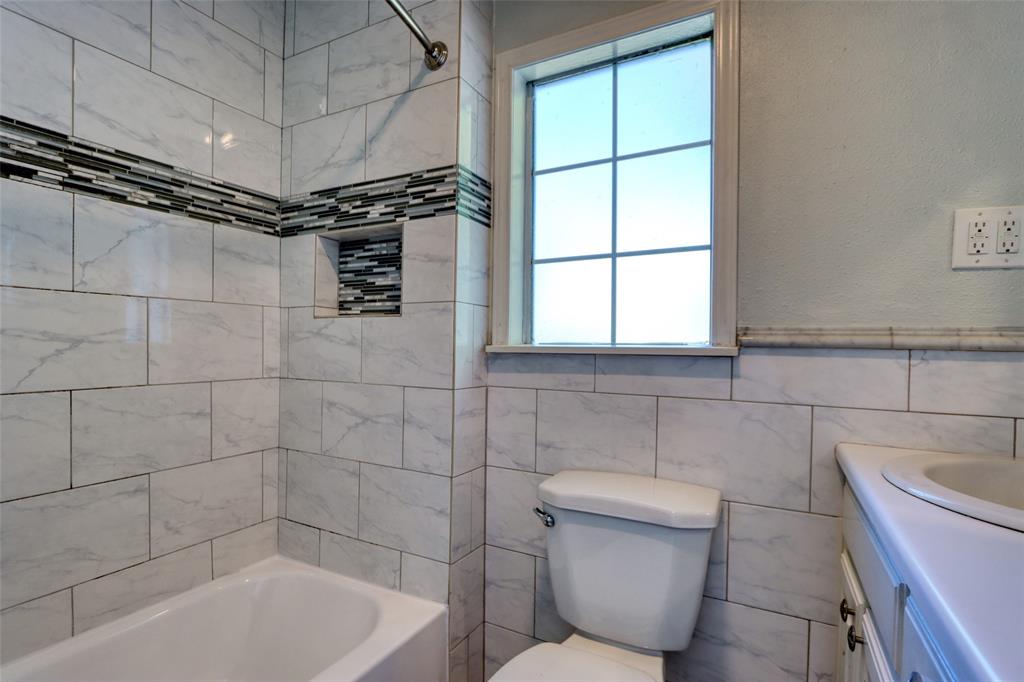 2222 Houston Street Grand Prairie, TX 75050 - Photo 11 of 24 a bathroom with a toilet and bathtub