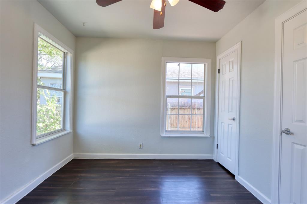2222 Houston Street Grand Prairie, TX 75050 - Photo 14 of 24 an empty room with wooden floor chandelier fan and windows
