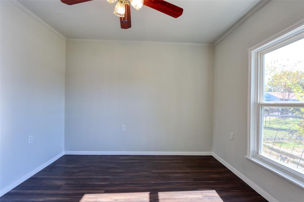 2222 Houston Street Grand Prairie, TX 75050 - Photo 16 of 24 an empty room with wooden floor and windows