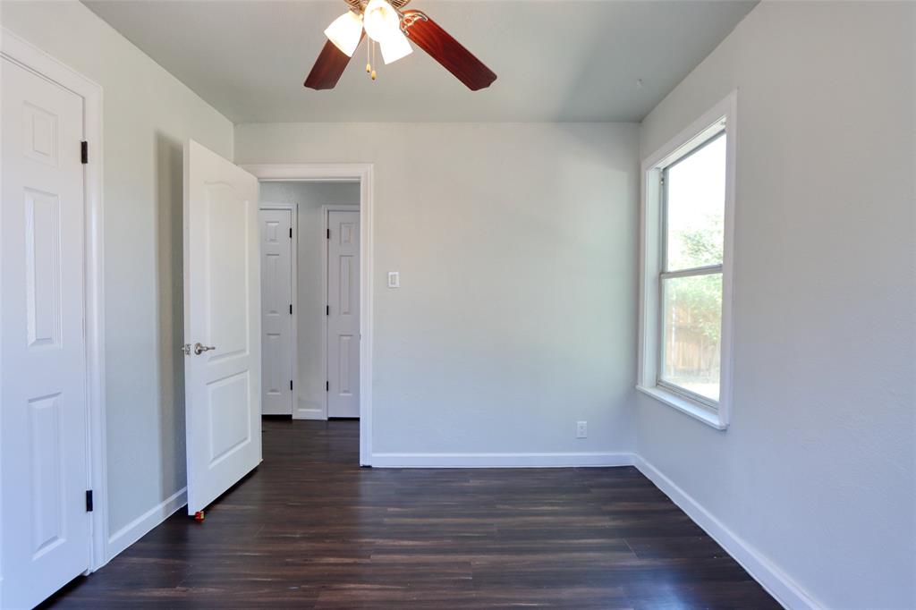 2222 Houston Street Grand Prairie, TX 75050 - Photo 17 of 24 an empty room with wooden floor and windows