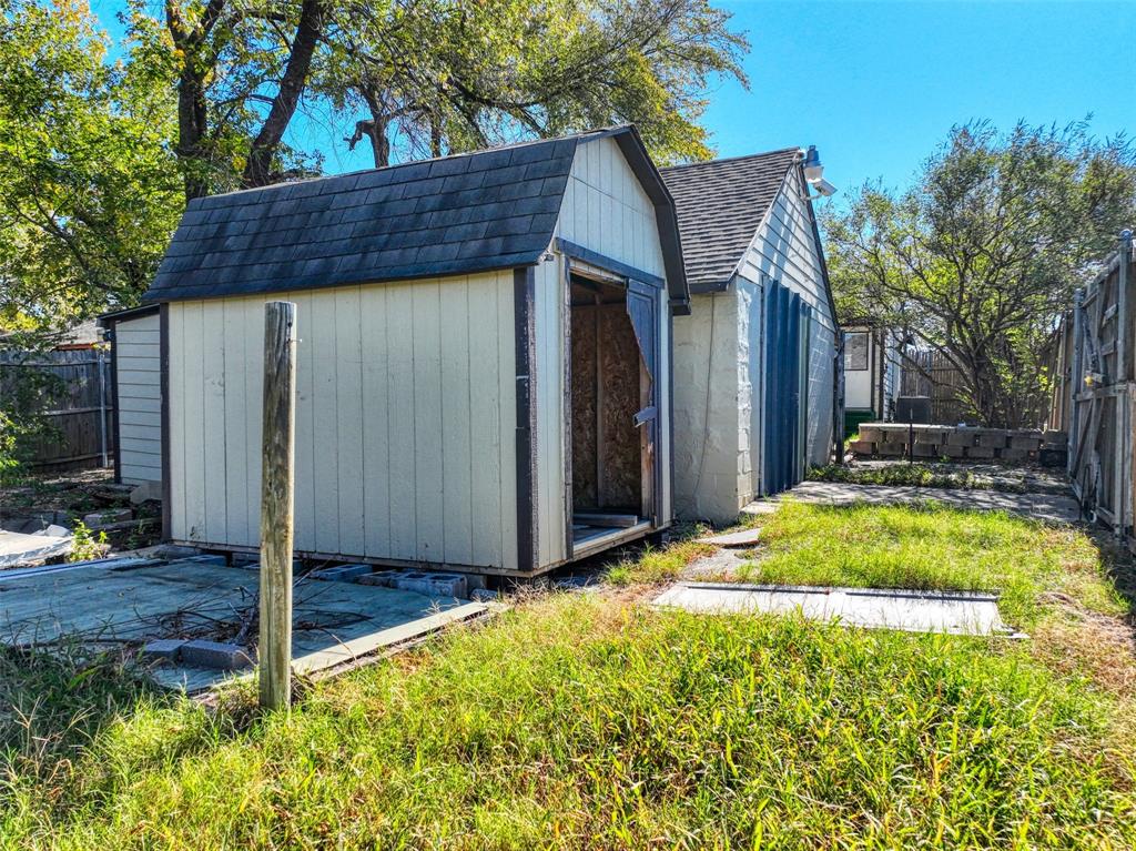 2222 Houston Street Grand Prairie, TX 75050 - Photo 20 of 24 a backyard of a house with wooden fence