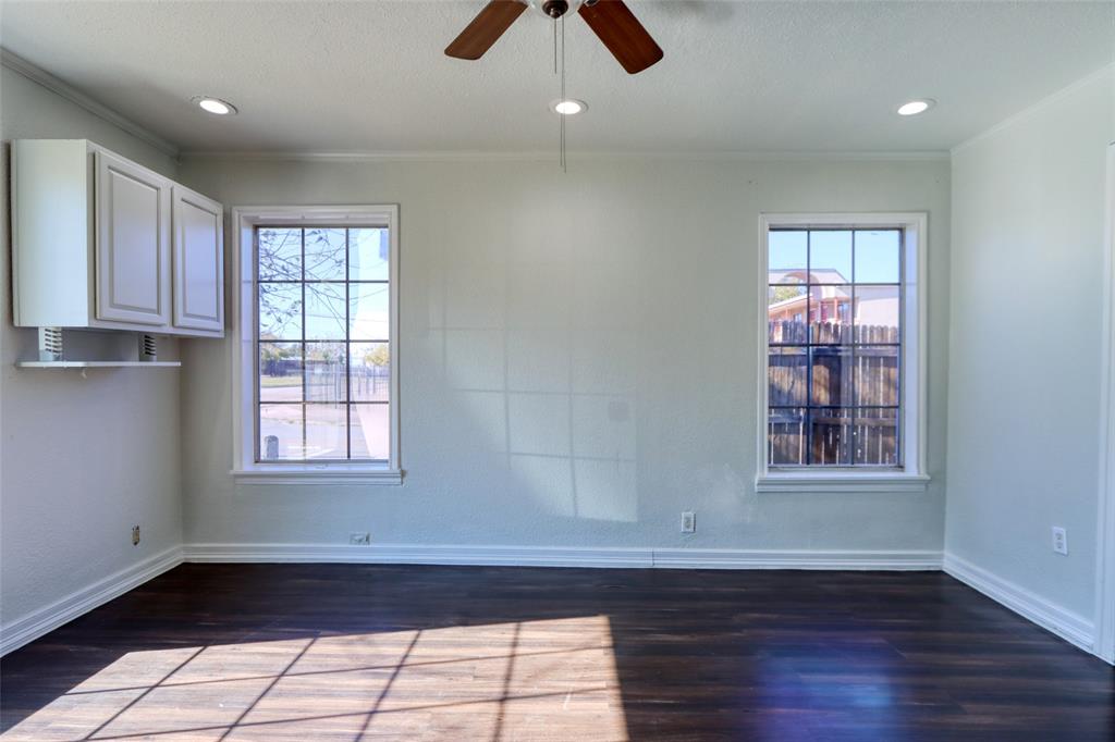 2222 Houston Street Grand Prairie, TX 75050 - Photo 3 of 24 a view of an empty room with wooden floor and window